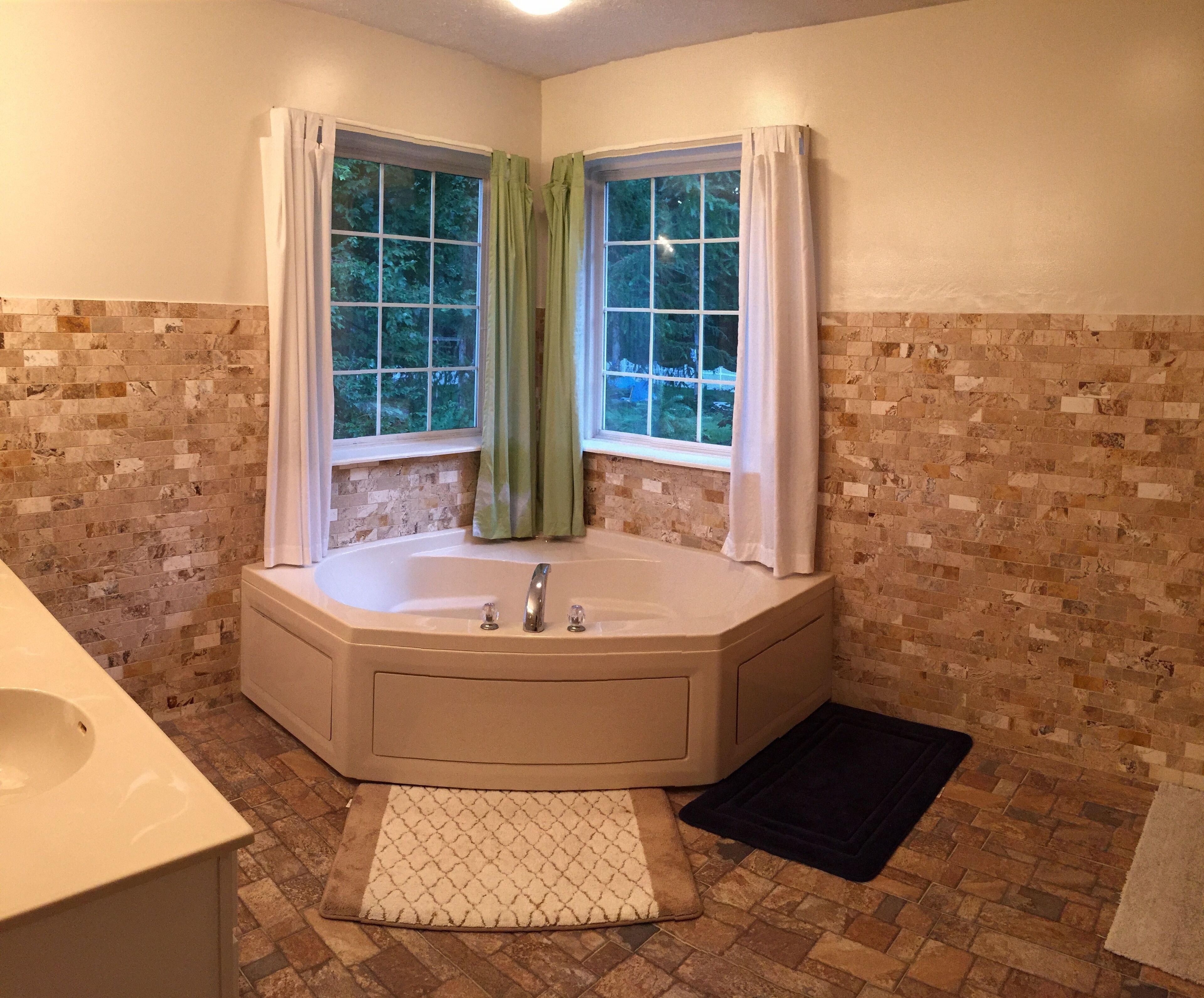 Bathtub, hair dryer, towels, toilet paper
