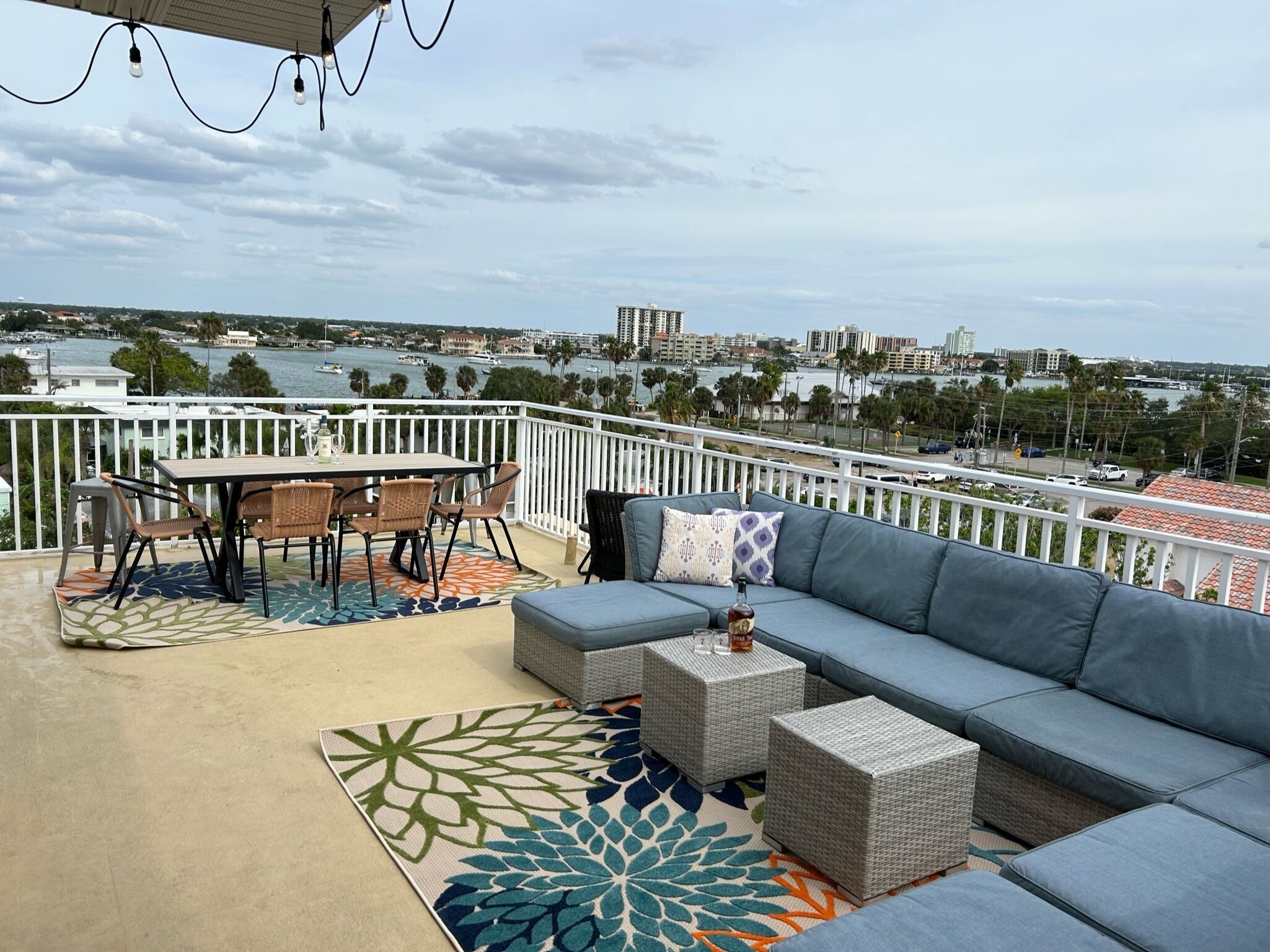 A balcony with a view of a marina and cityscape.