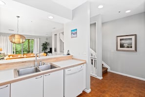 Kitchen features a stainless steel sink, dishwasher, and ample counter space.