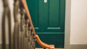 A green door with a brass handle and a brass doorknob. - APPARTAMENT IN THE CITY CENTER OF FLORENCE (Firenze)
