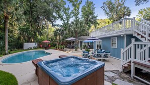 A backyard with a swimming pool, hot tub, and outdoor seating area. -  VACAY TIME:HHI Retreat: Pool/Hot Tub/Near Beach, Pets, Last Minute Rentals Now! (Hilton Head Island)