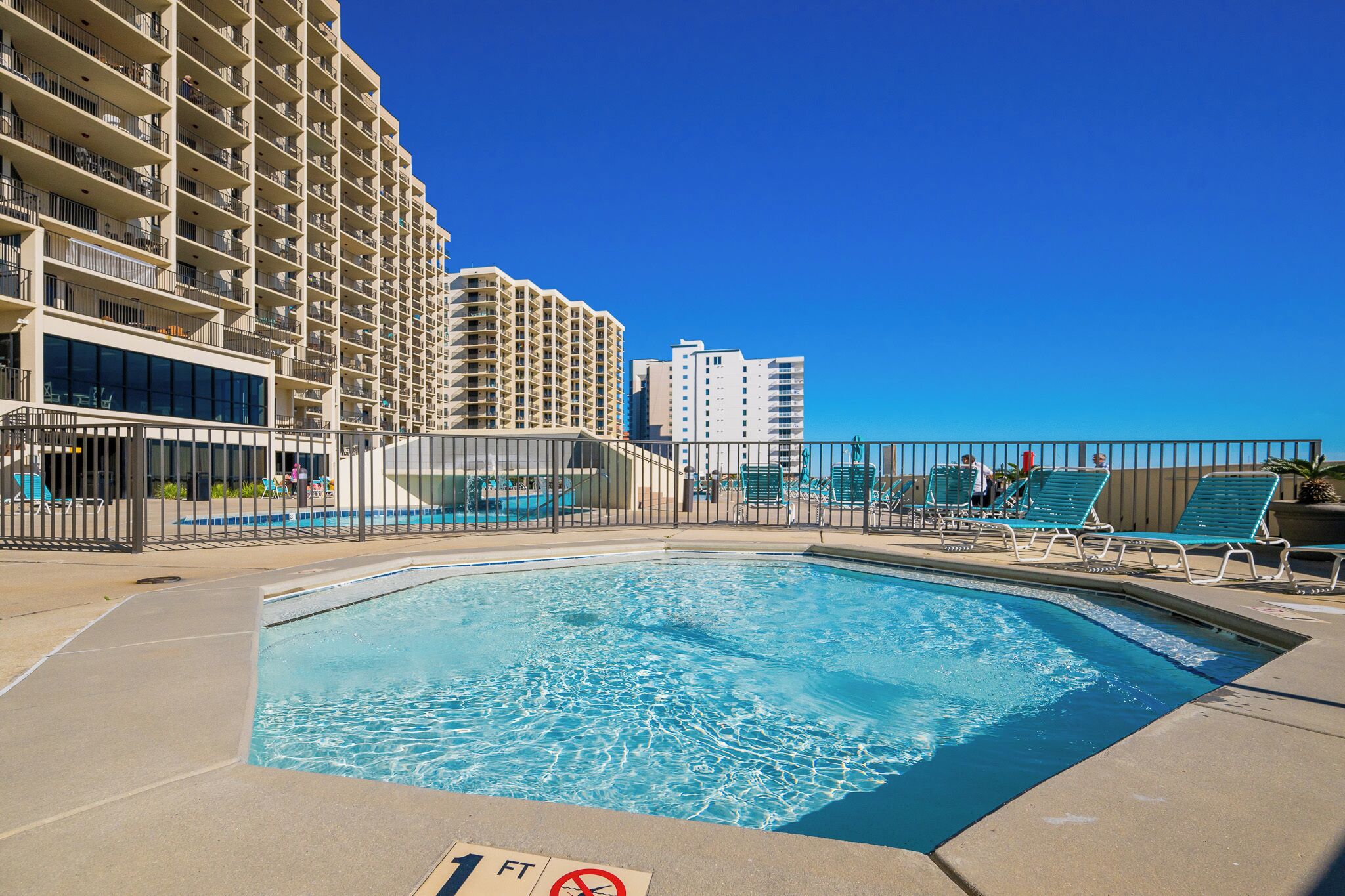 Splash around in the kiddie pool with the little ones on your next beach retreat to Phoenix VII in Orange Beach