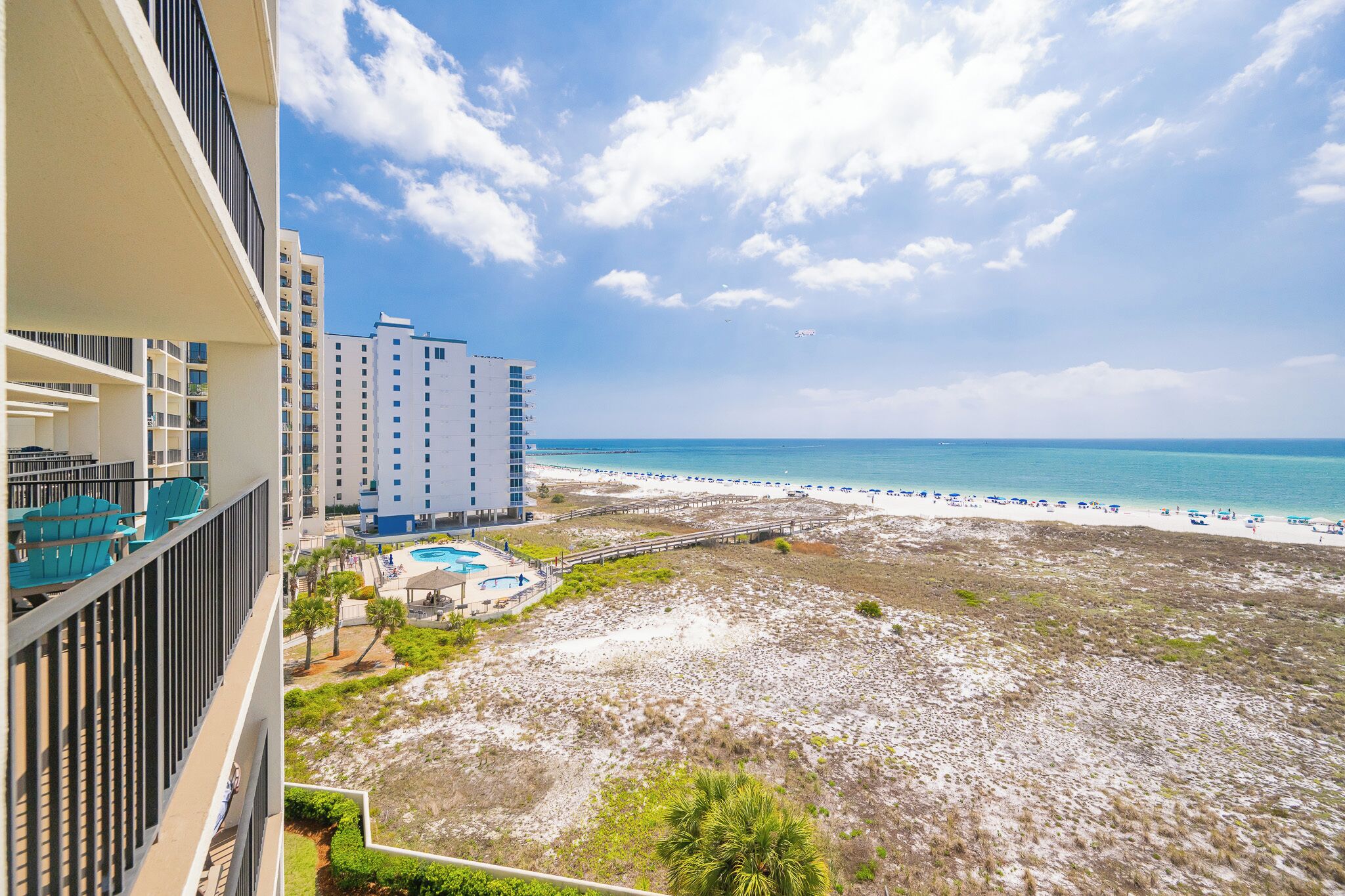 A beachfront hotel with a pool, beach, and ocean view.