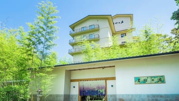 A building with a traditional Japanese architectural style, featuring a flat roof and a wooden entrance.