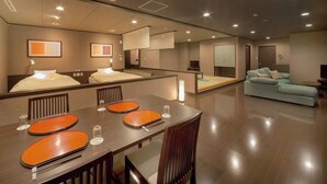 A modern hotel room with a dining area, a sofa, and a TV. - Shofurou Matsuya (Nasushiobara)