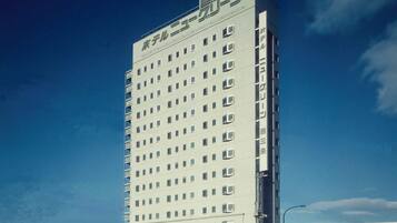 A tall, multi-story building with a uniform facade and numerous windows.