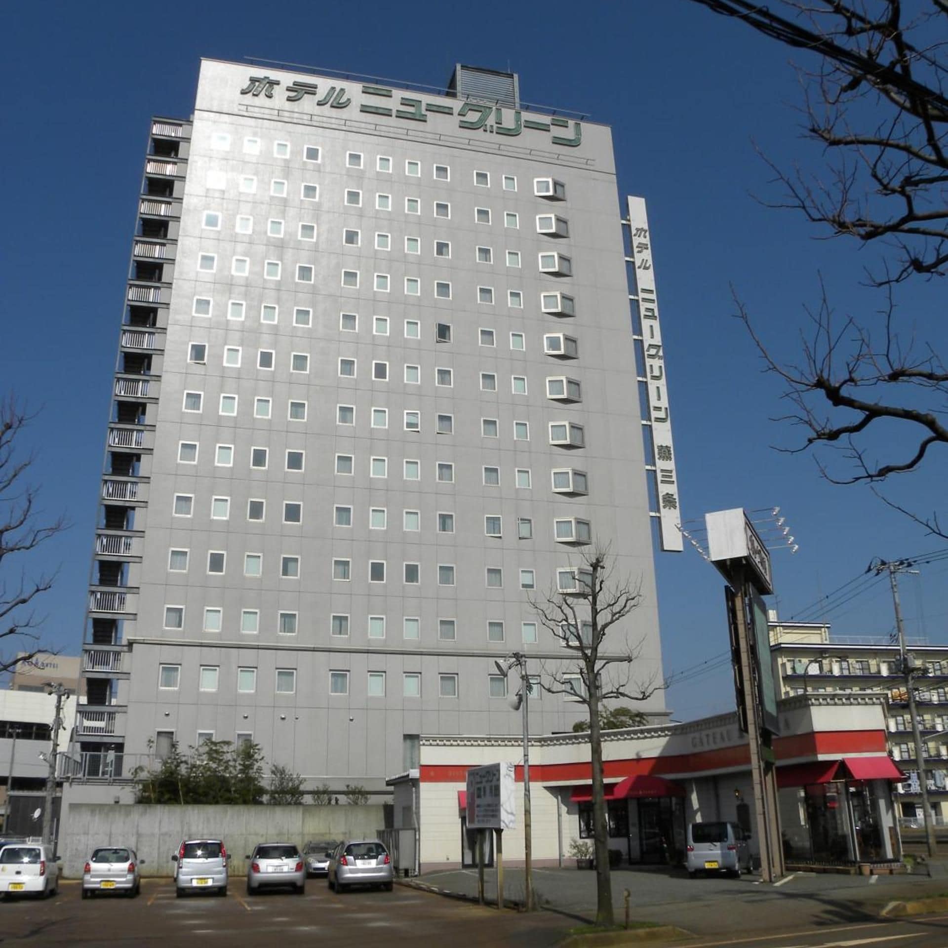 A multi-story hotel with a modern facade, numerous windows, and a visible sign indicating it is a hotel.