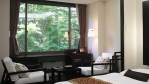 A hotel room with a large window, a bed, a desk, a chair, and a lamp. - Shiobara Onsen Okushiobara Kogen Hotel (Nasushiobara)