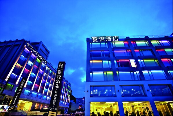 A hotel with multiple floors and illuminated windows.