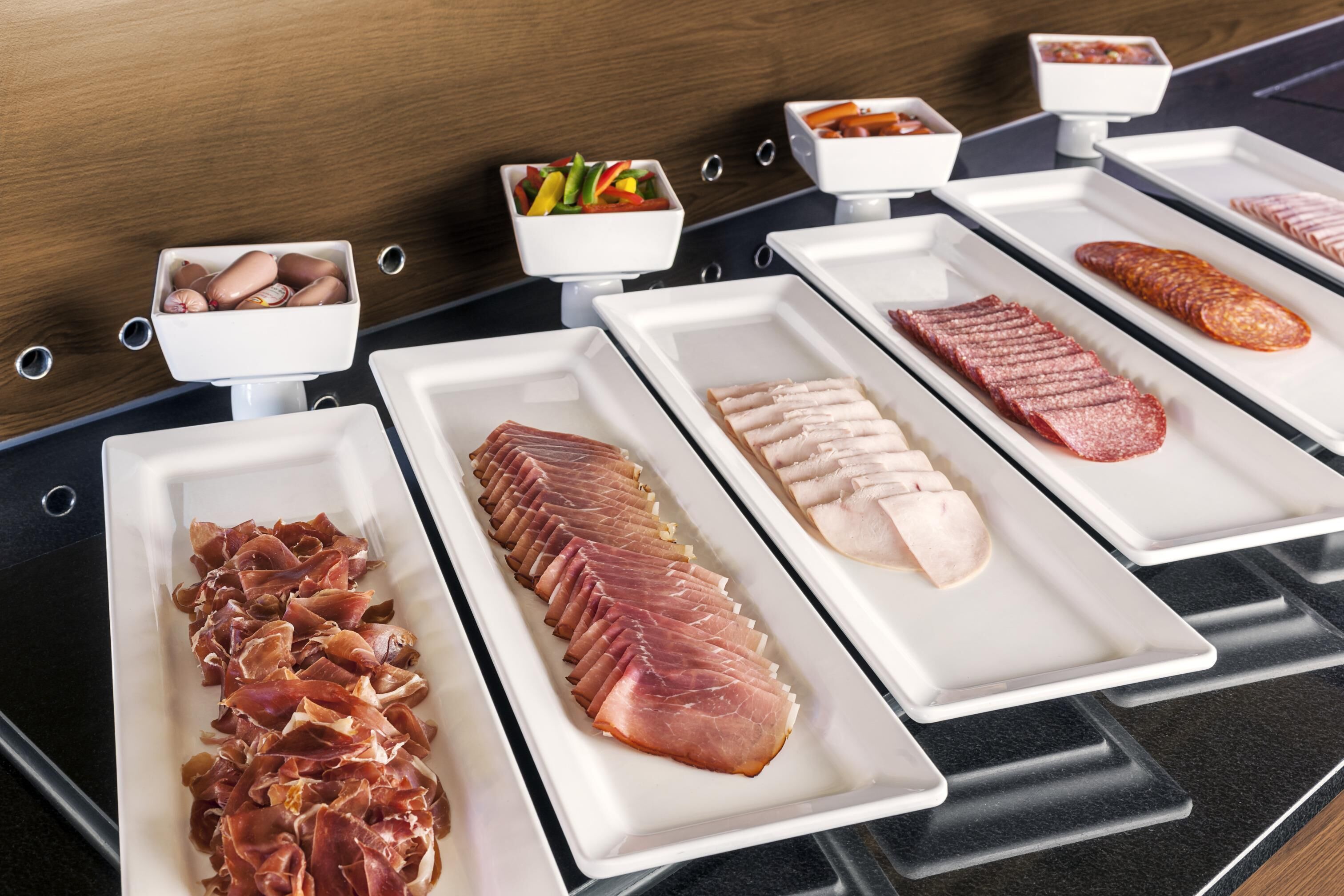 A buffet with various meats and vegetables.