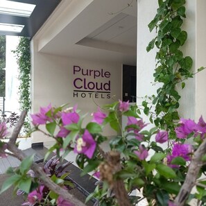 A hotel entrance with a sign reading 'Purple Cloud Hotels.' - Purple Cloud Hotel (Bengaluru)