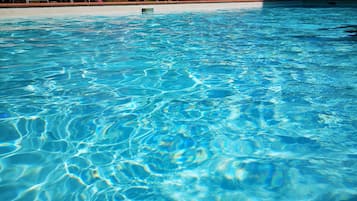 Seasonal outdoor pool, open 10:00 AM to 8:00 PM, pool umbrellas