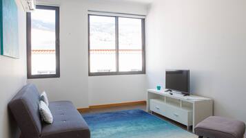 Departamento, 1 habitación | Área de sala de estar | Televisión de pantalla plana
