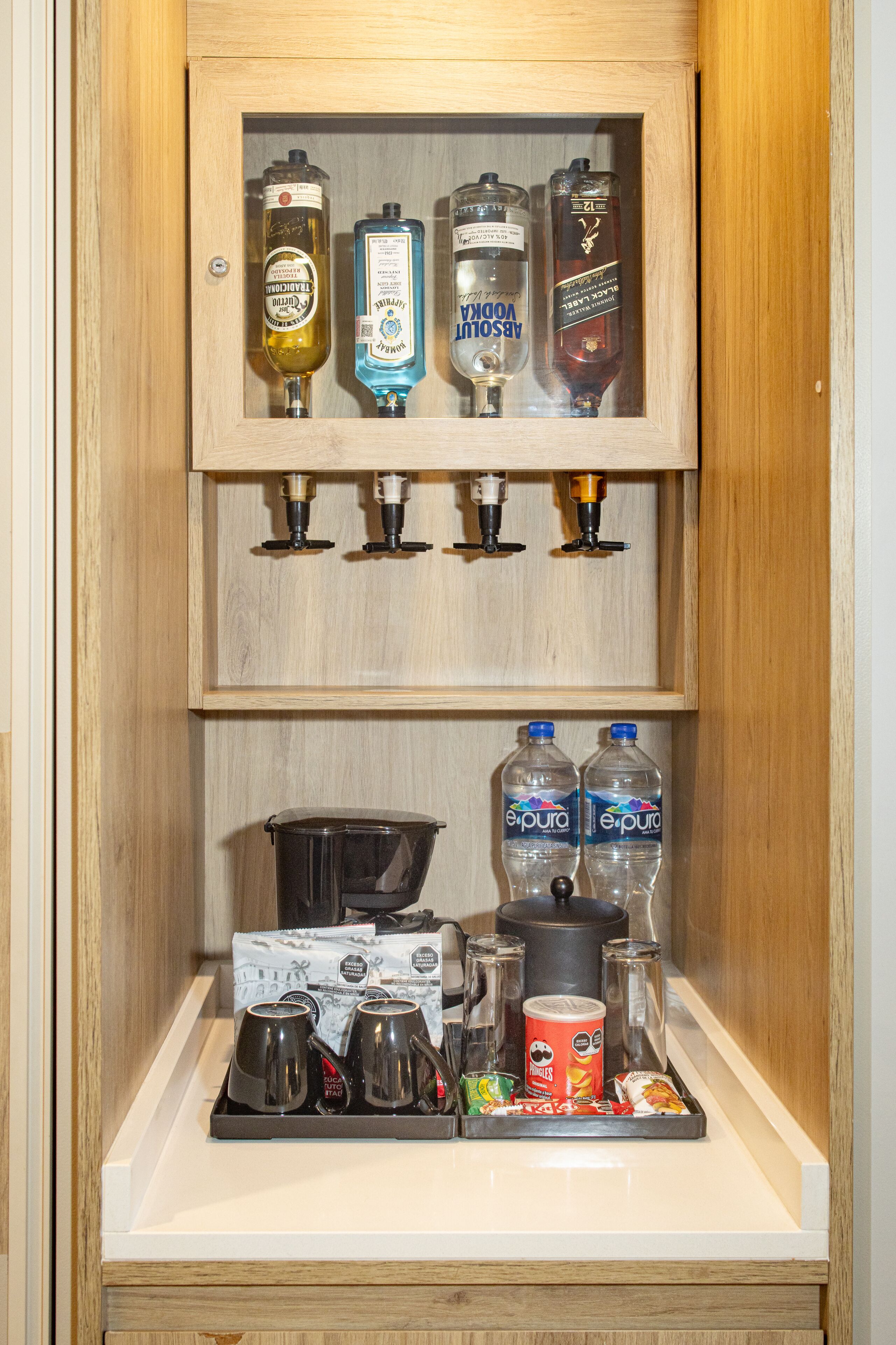 A minibar with various beverages and snacks.