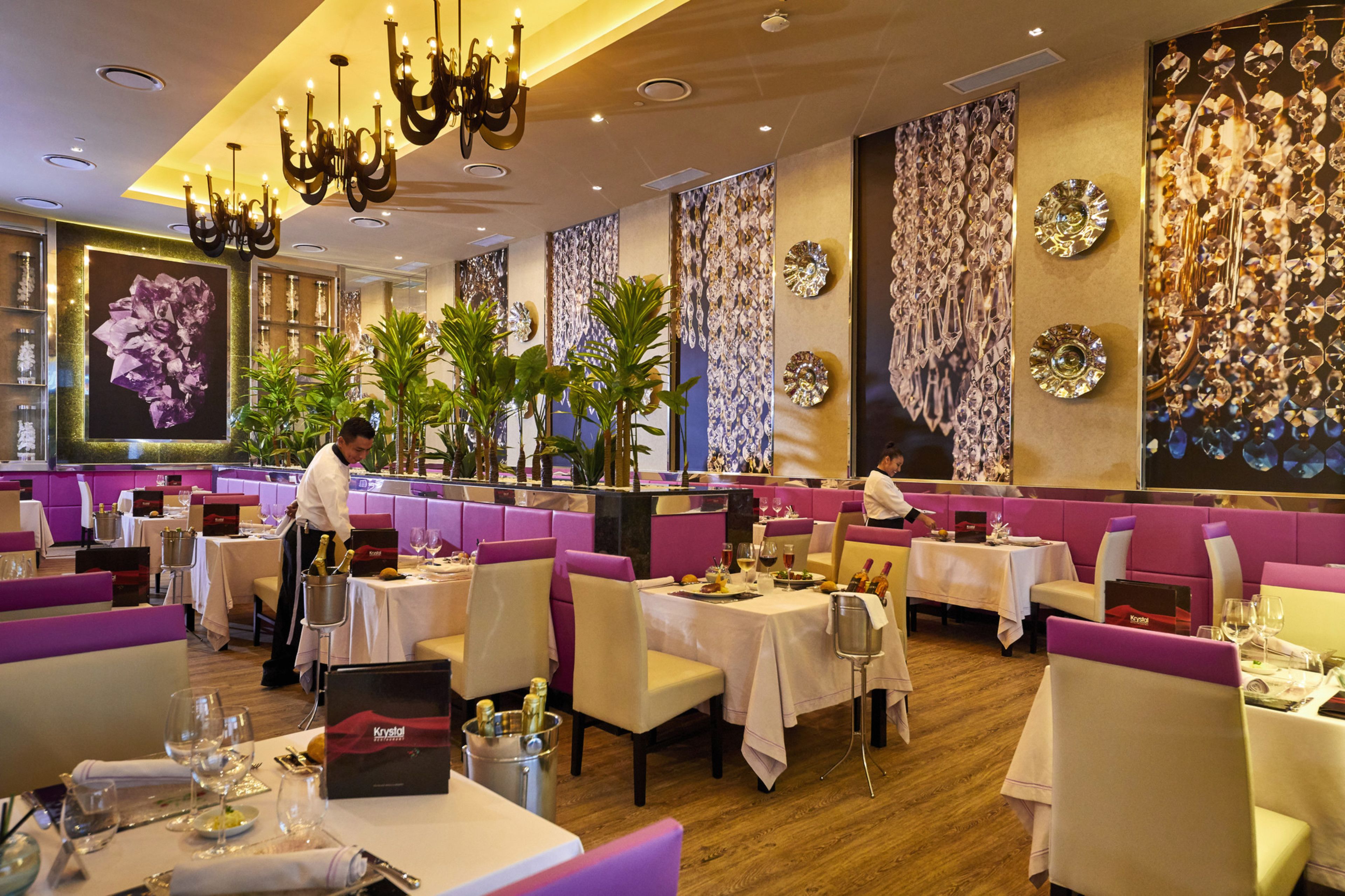 A restaurant with booths, tables, and a bar area.