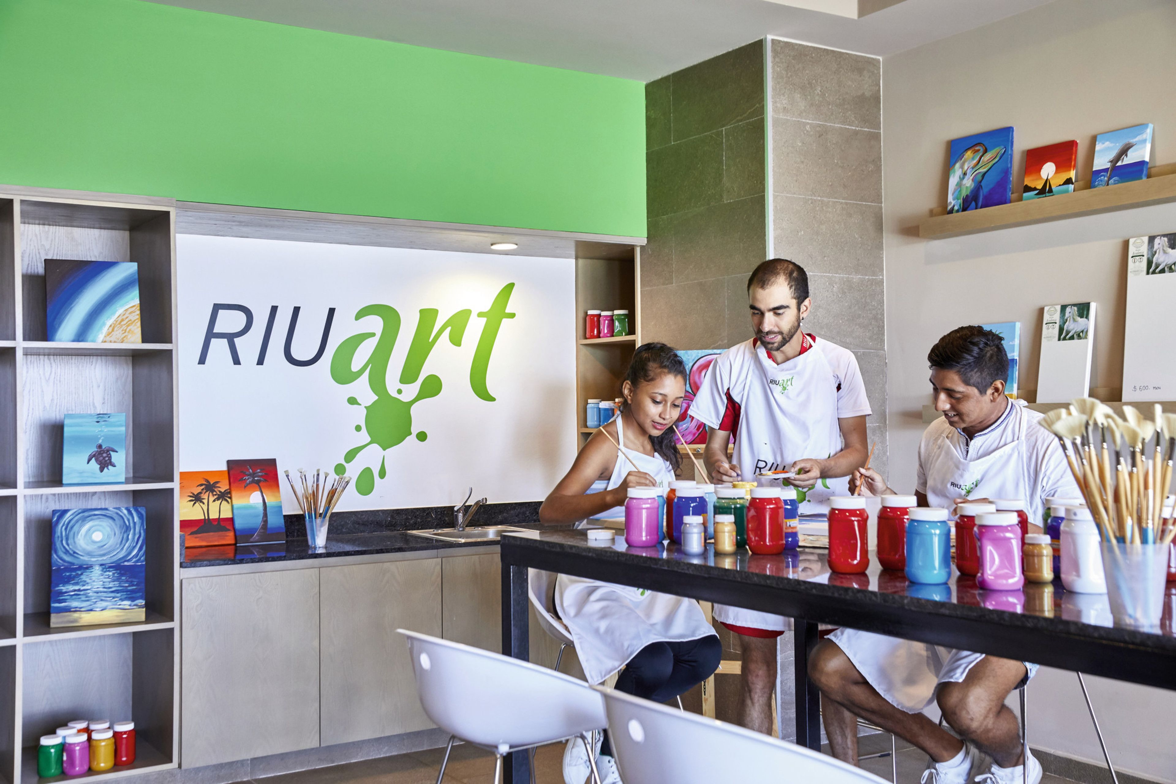 Un atelier d’art Riuart doté d’un mur végétal, de matériel de dessin et de peintures.