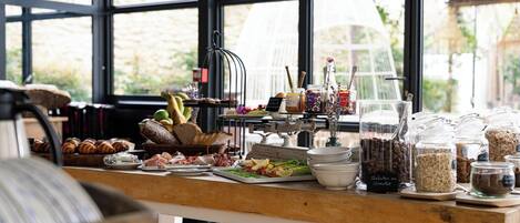 A buffet table with various food items and condiments.