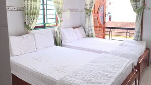 A hotel room with two beds, a window with green curtains, and a view of the outside. - Sunrise Guesthouse (Quy Nhon Nam)