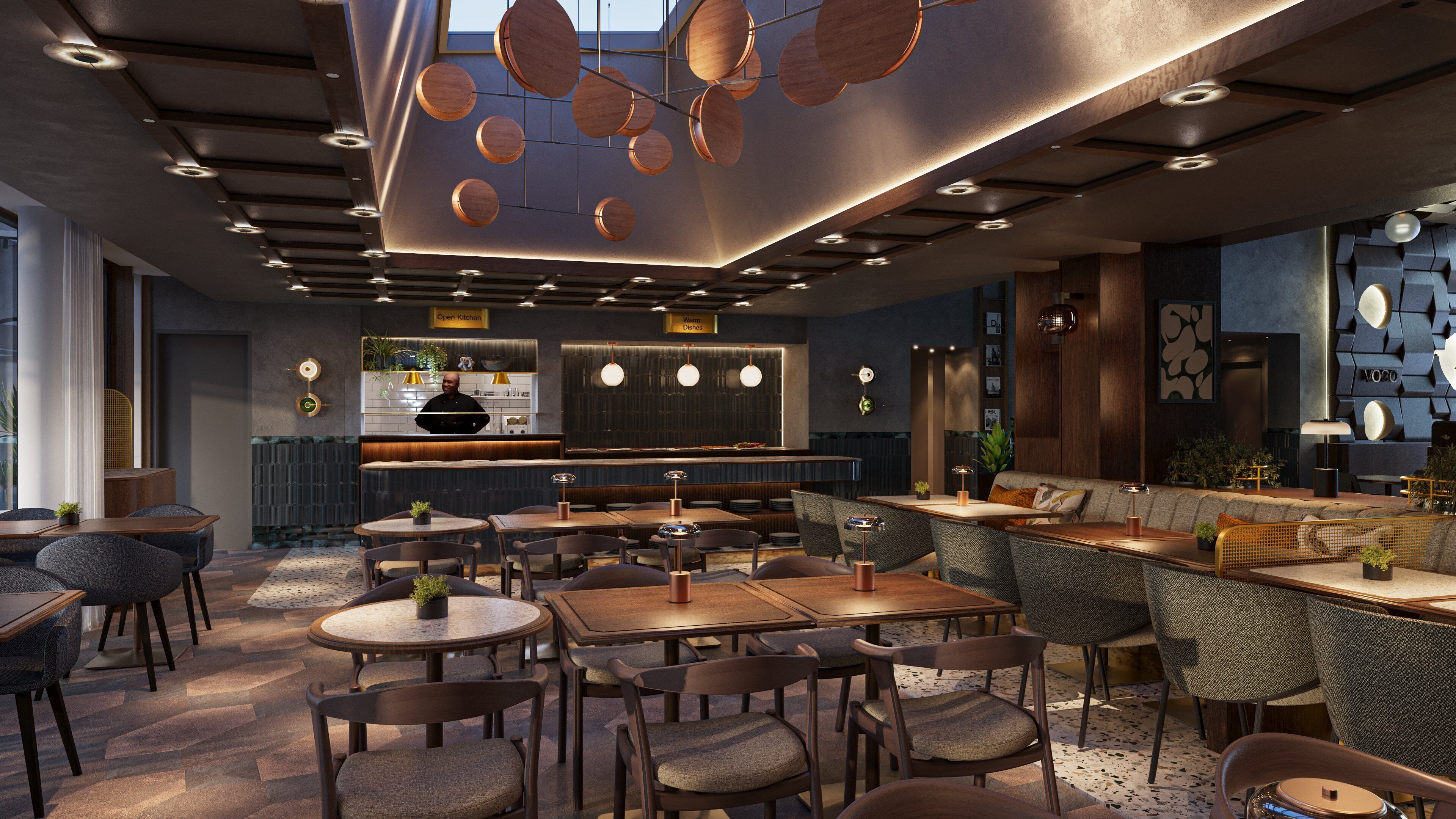 A modern restaurant interior with round tables, cushioned chairs, a bar area, and a chef at the counter.