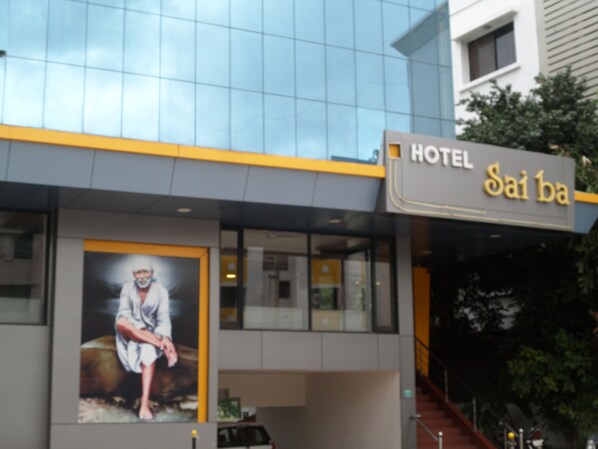 A hotel named "Sai ba" with a modern facade, large windows, and a prominent poster of a person. - Hotel Sai Ba (Rahata)
