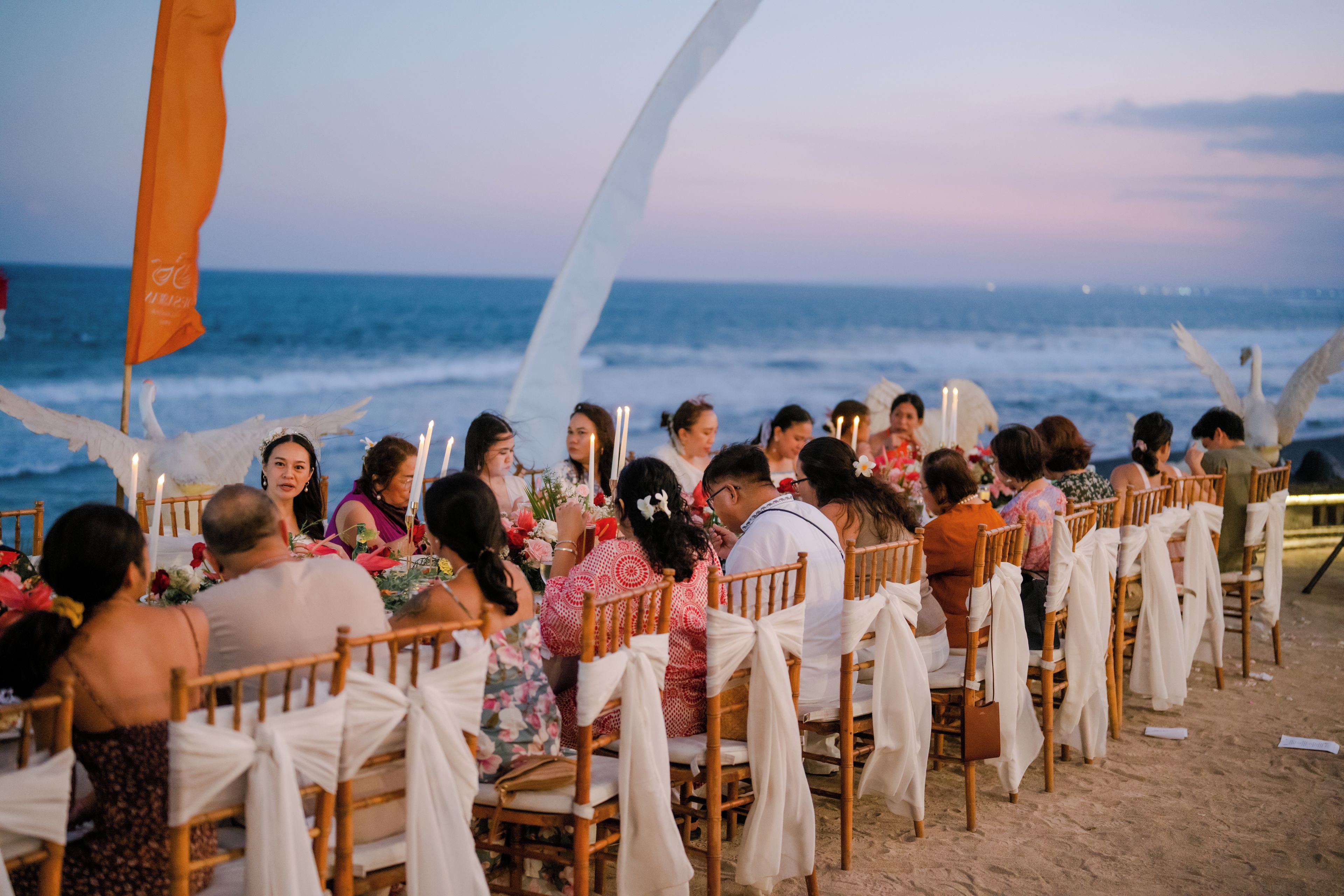 Evento frente al mar con invitados sentados en filas mirando al océano.