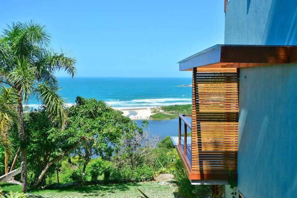 A coastal view with a wooden balcony overlooking the ocean.