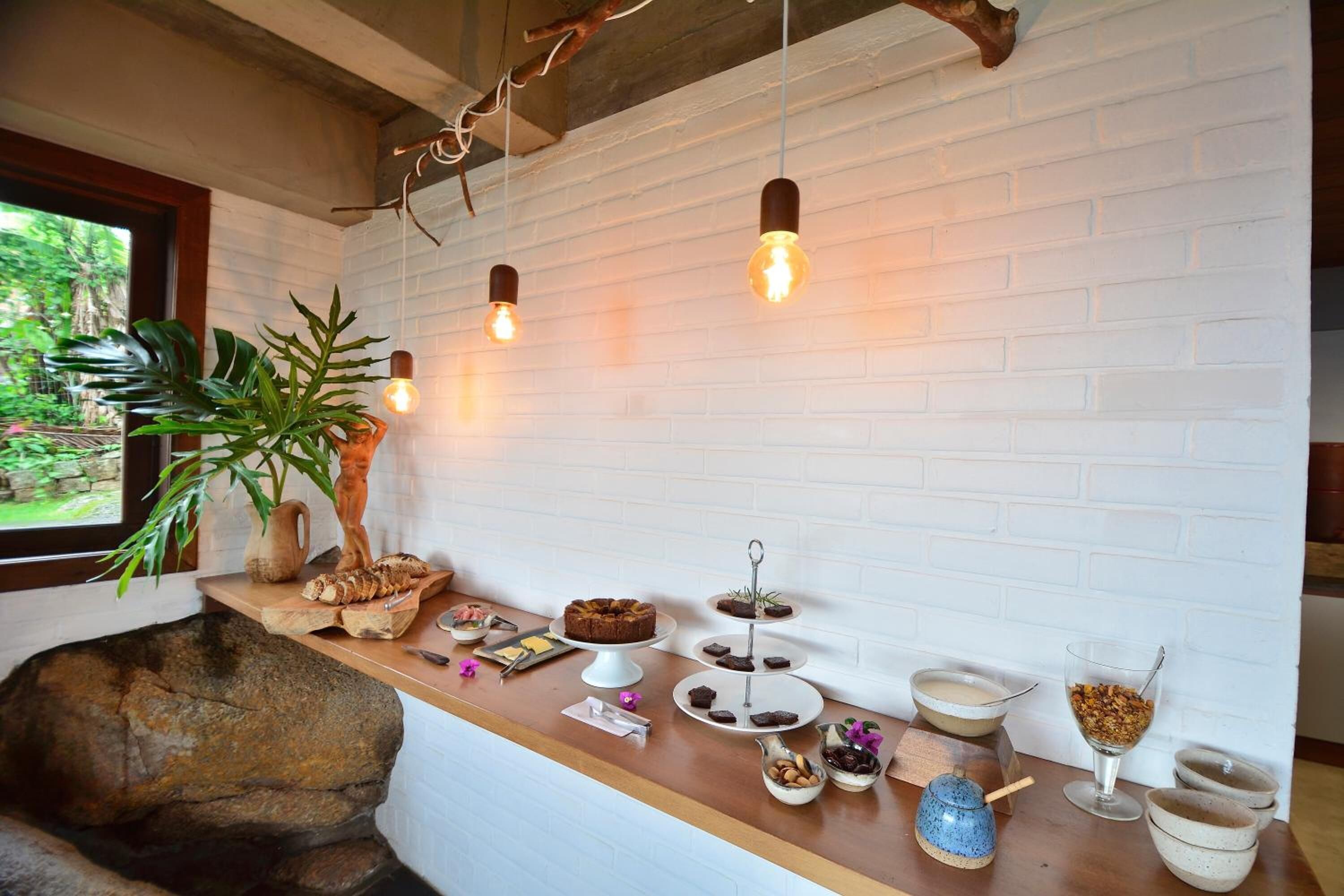 A kitchen counter with a variety of food items and a potted plant.