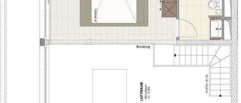 A floor plan of a hotel room with a bathroom, a small sitting area, and a balcony.