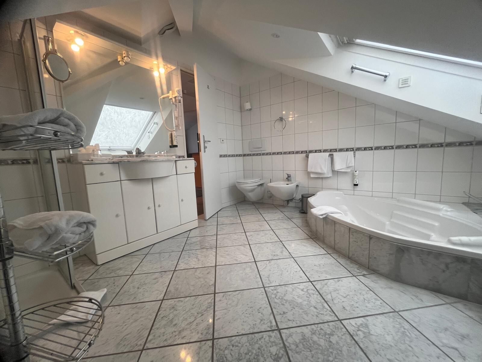 exclusive studio suite | bathroom | hair dryer, towels, soap, shampoo