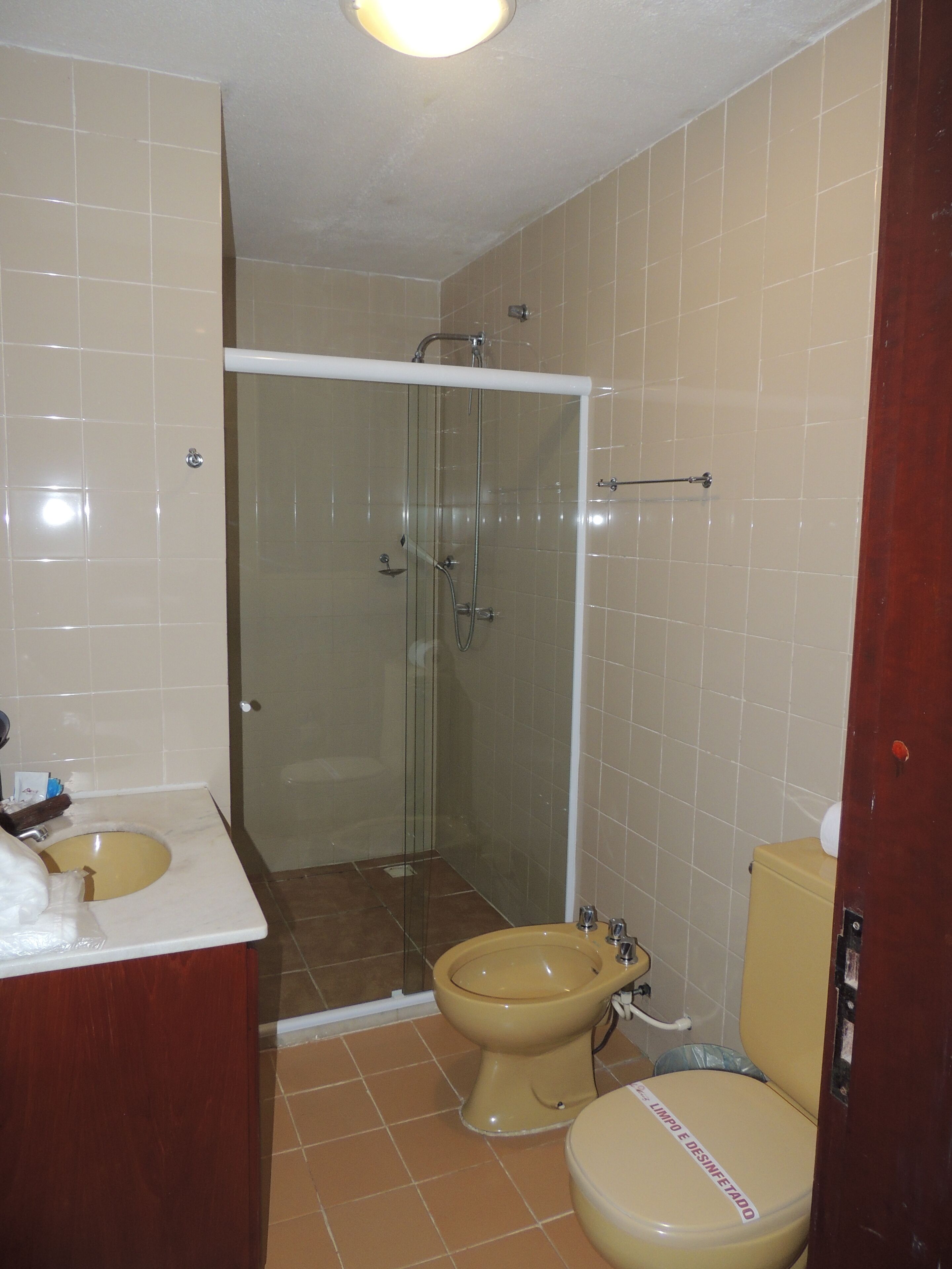 A bathroom with a shower, toilet, and sink.
