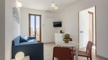 Apartment, 1 Bedroom, Balcony, City View | Living area | Flat-screen TV