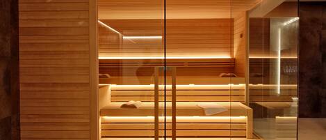 A modern spa area with wooden benches and a glass partition.
