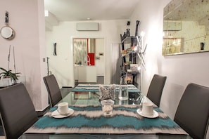 A modern dining area with a glass table, leather chairs, and a decorative runner. - Istanbul Irini Seaview House (Istanbul)