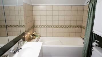 A bathroom with a bathtub, a sink, and a toilet.