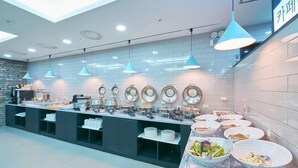 A buffet setup with multiple serving stations, a variety of dishes, and blue pendant lighting. - Hound Hotel Sangmu (Gwangju)