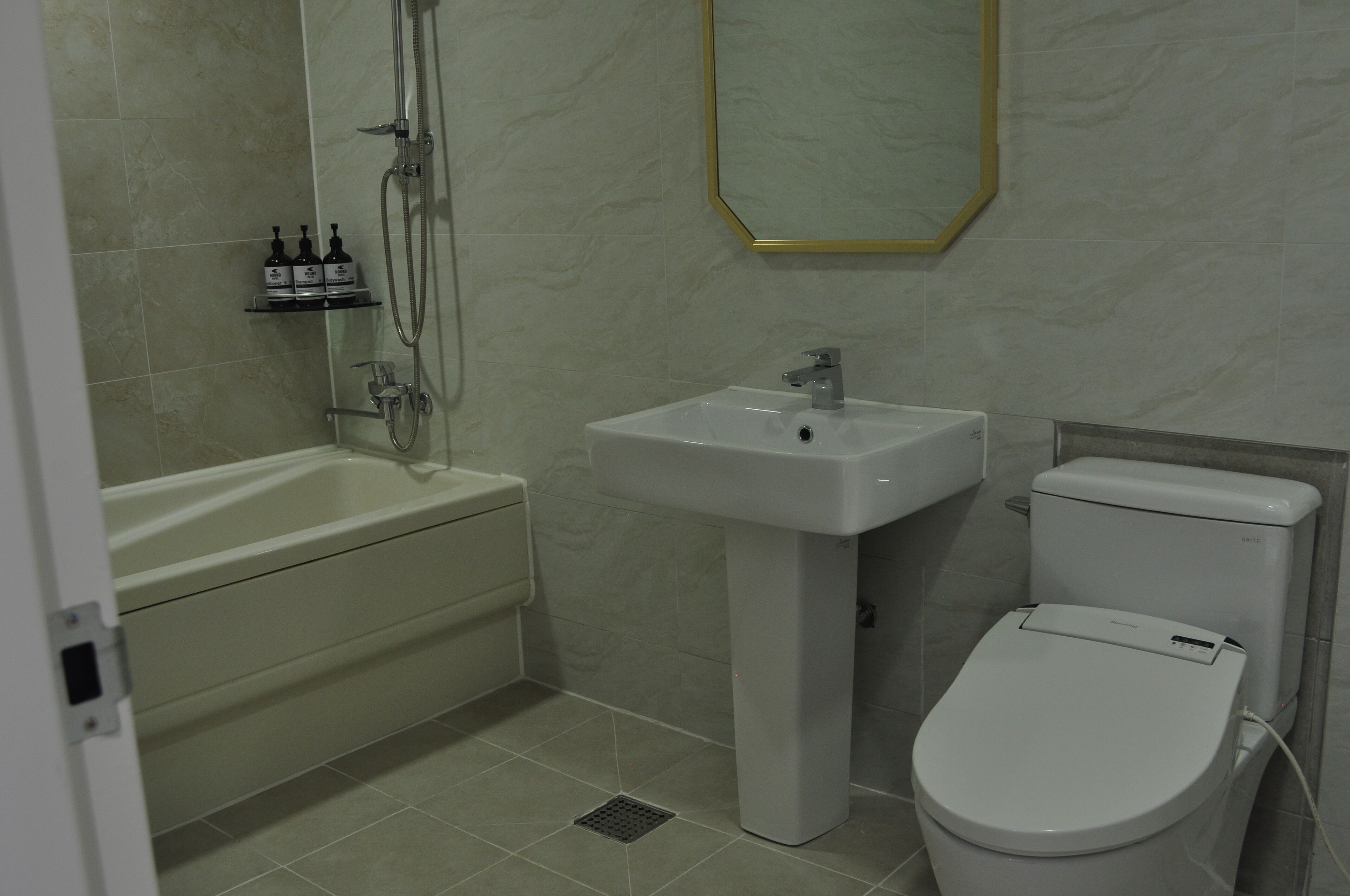 A bathroom with a bathtub, sink, and toilet.
