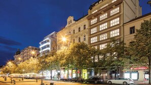 A street lined with historic buildings, some with balconies and large windows, under a night sky. - Pytloun Boutique Hotel Prague (Prague)