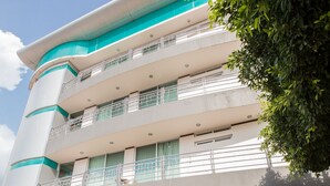 A modern hotel with a prominent sign reading "Tierra Viva Hotel". It features multiple balconies and large windows, with a clear sky above. - Tierra Viva Hotel (Comitan de Dominguez)