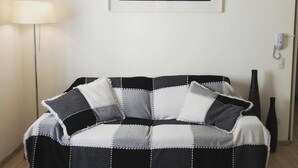 Apartment (K1X$02) | Living room | 42-inch LCD TV with cable channels, TV