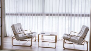 A modern room with two beige armchairs and a wooden coffee table. - Atami Kinomiyanoyu Shogetsu (Atami)