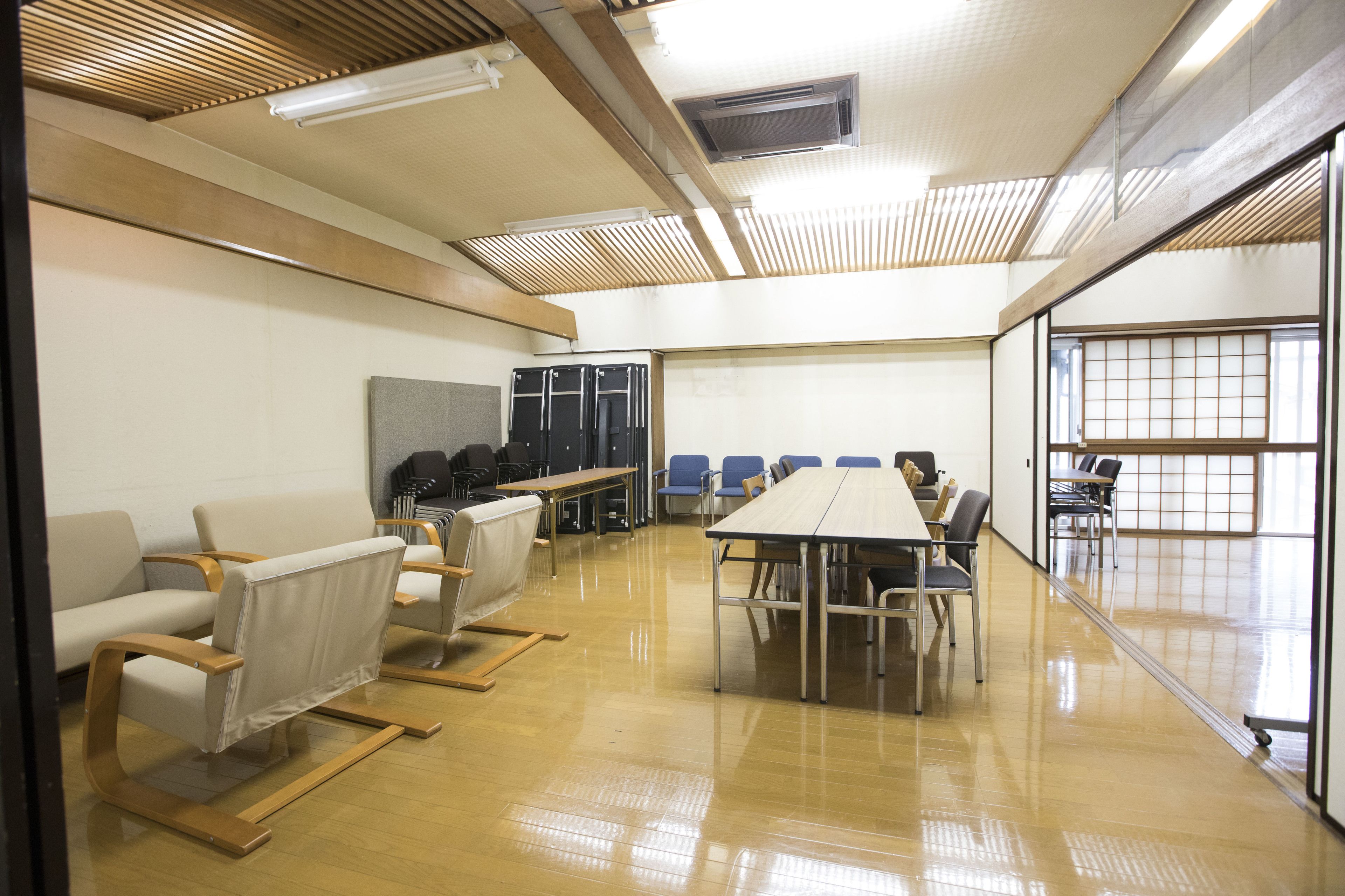 A conference room with a long table, chairs, and a whiteboard.