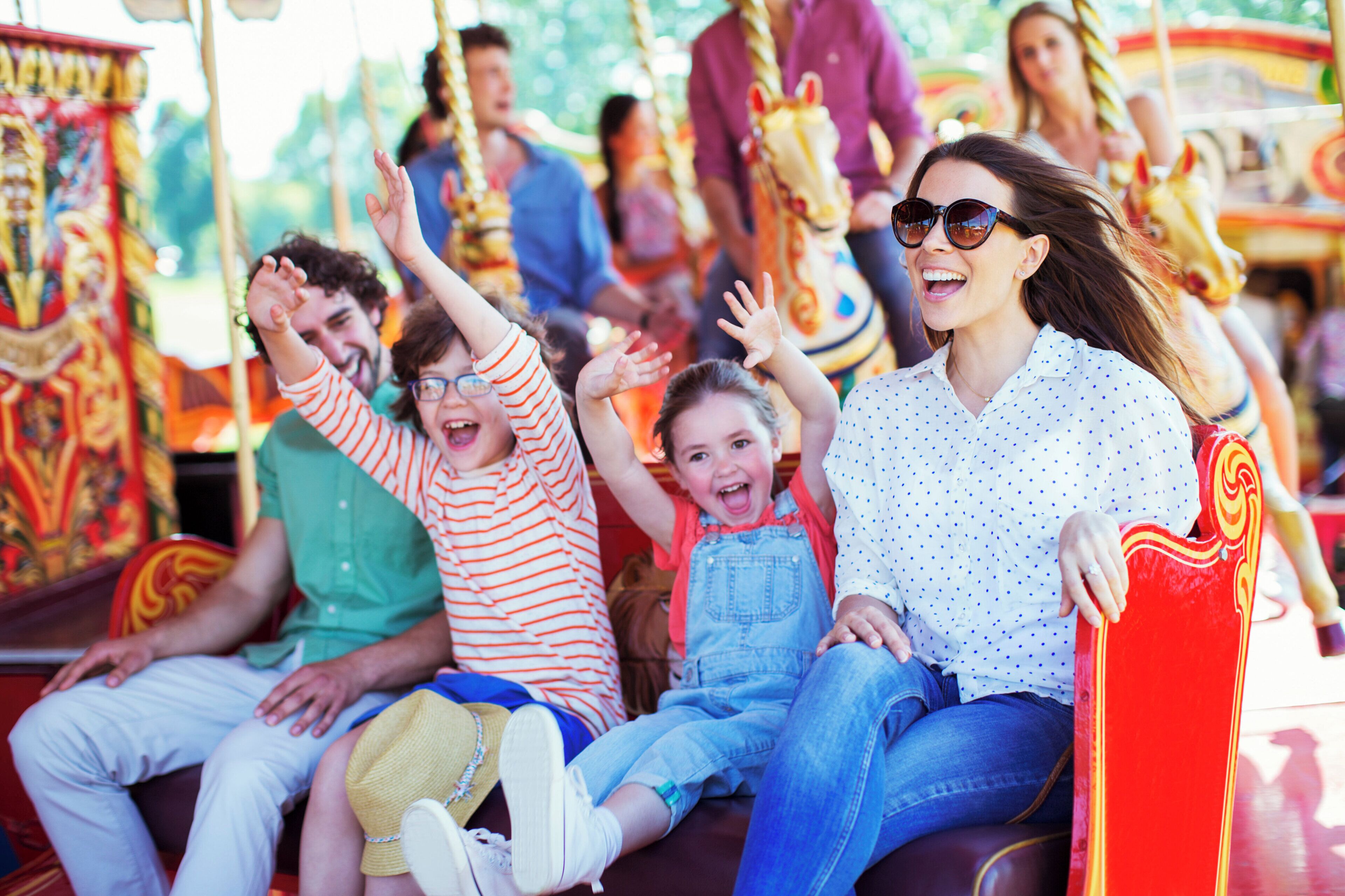 A carousel with people seated on it.