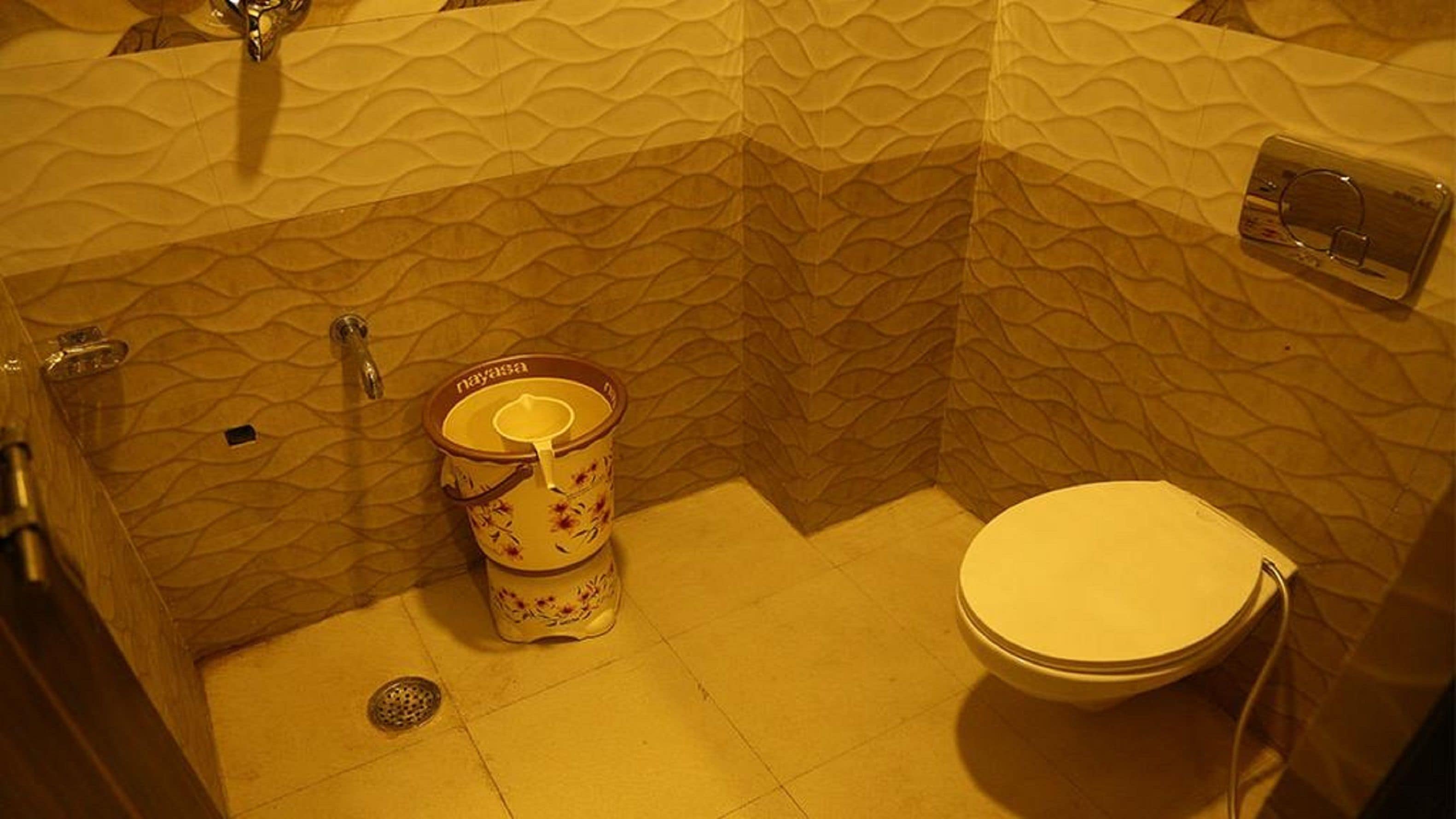 A bathroom with a toilet, a bidet, and a shower.