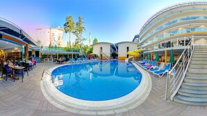 A pool area with lounge chairs, a staircase, and a dining area with tables and chairs. - Arsi Enfi City Beach Hotel (Alanya)