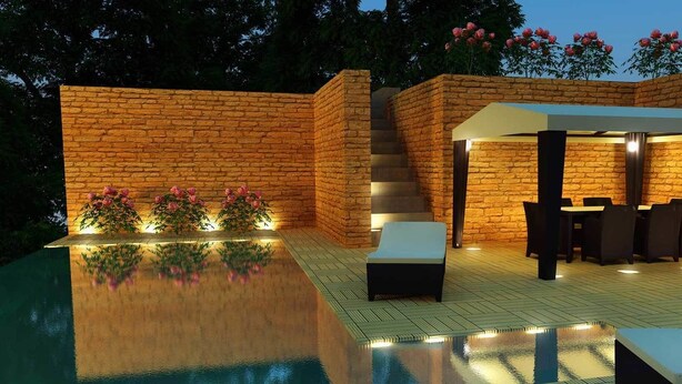 A poolside area with a brick wall, a covered seating area, and a staircase. - Treebo Ashoka Palace Ujjain (Ujjain)