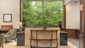 A modern kitchen with a large window, a dining area, and a wooden cabinet. - The Chinar Resort & Spa, Pahalgam (Anantnag)