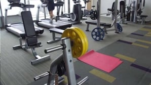 A gym with treadmills, weight machines, and a weight rack. - NorthPoint Pattaya with Sea View (Pattaya)