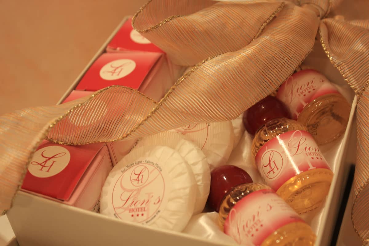 A box of chocolates and a bottle of wine with a ribbon.