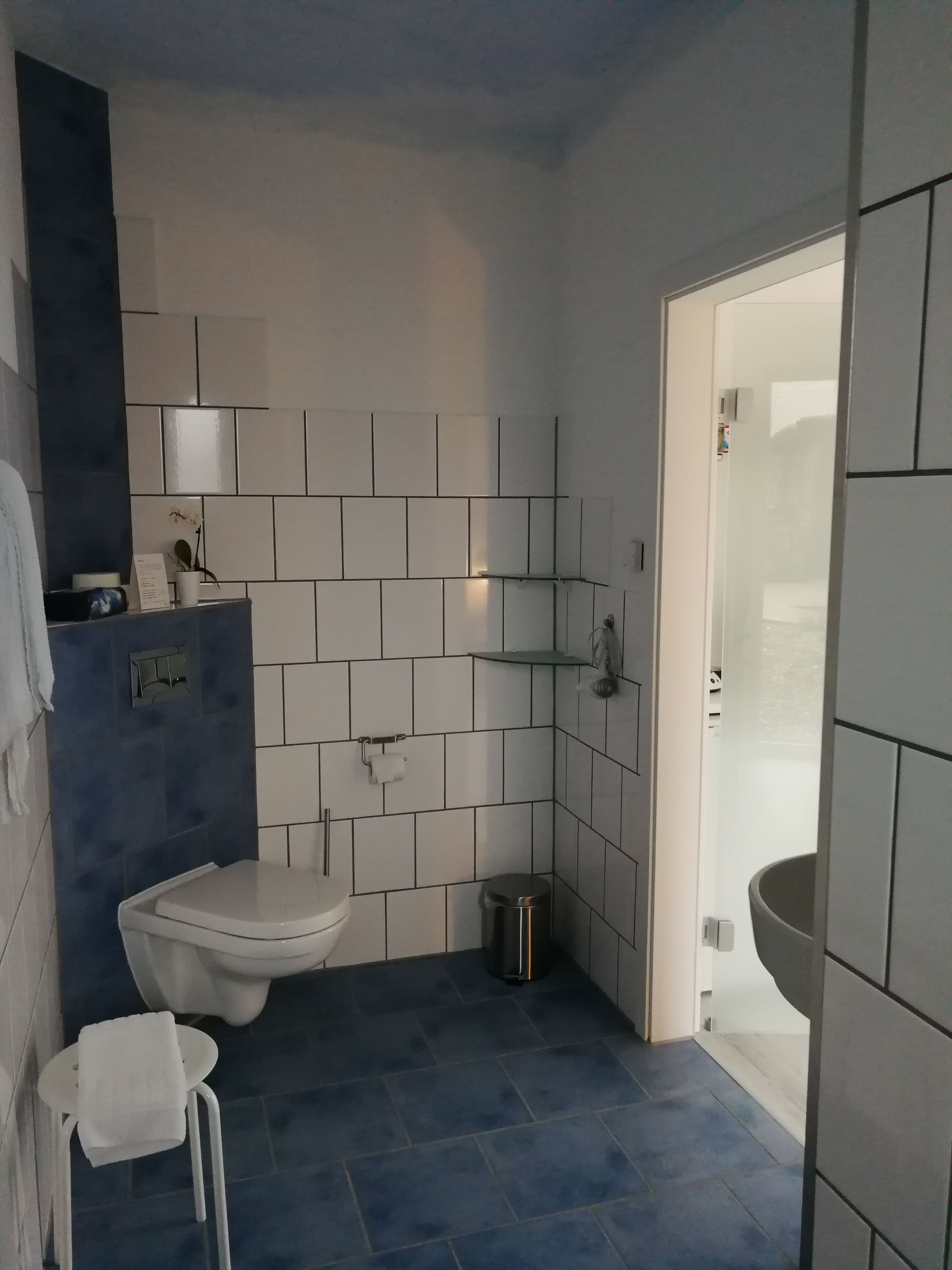 A modern bathroom with a toilet, sink, and shower area.