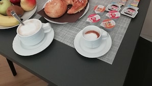 A breakfast table with croissants, fruits, juice, and Nutella packets. - Little Rock (Gaeta)